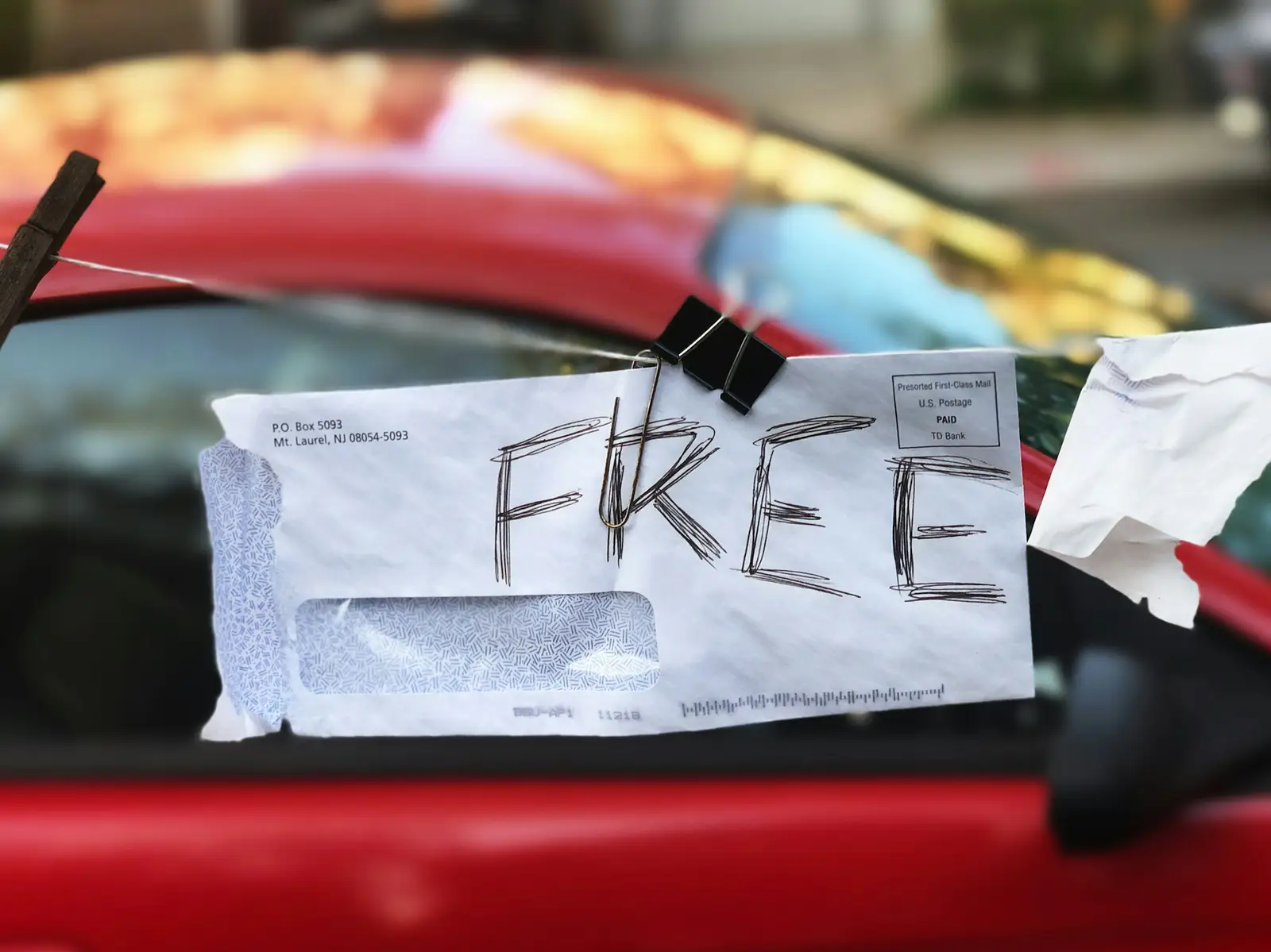 Feuille « free » coincée sous un essuie-glace