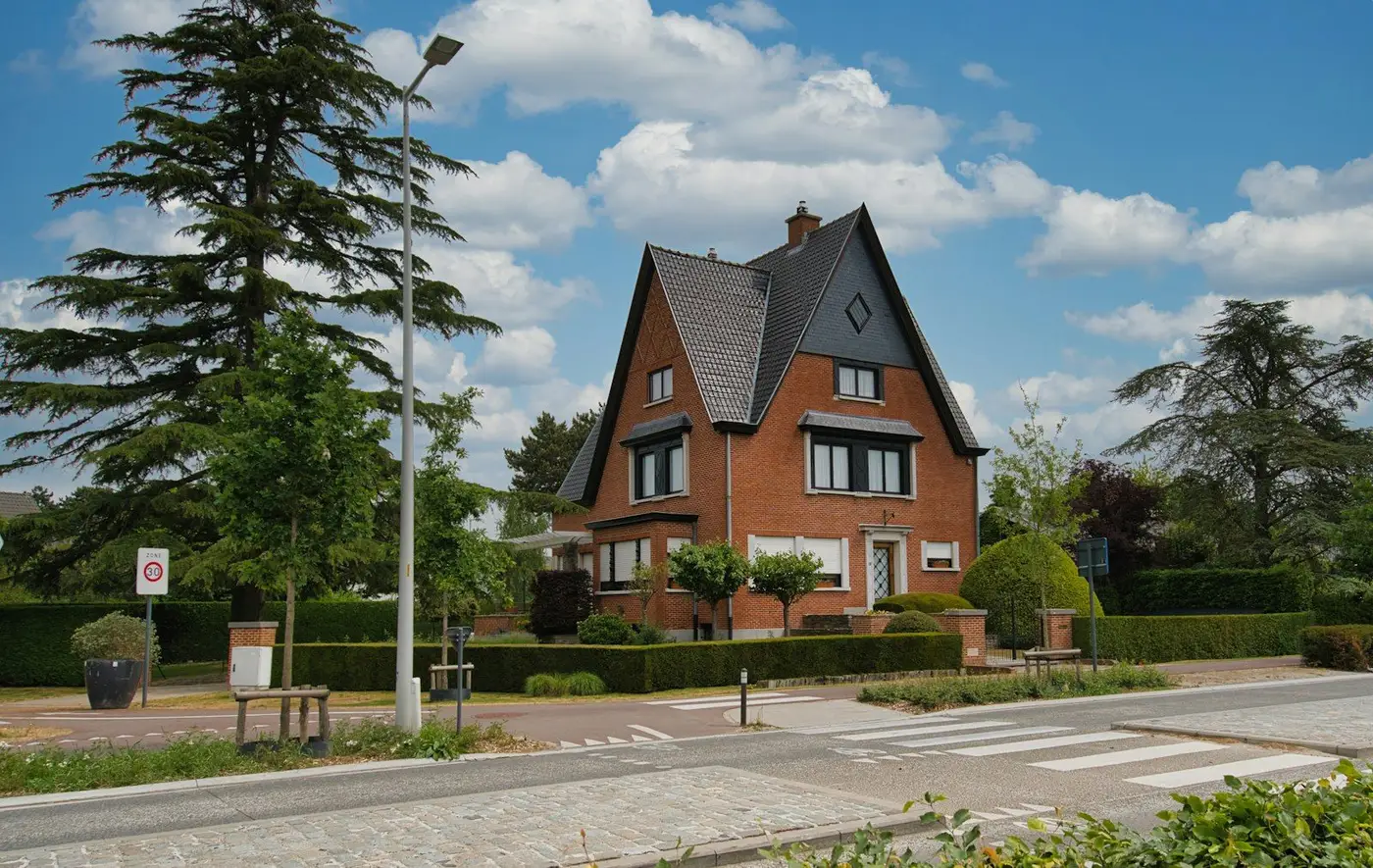 Maison en briques au toit pentu et son jardin